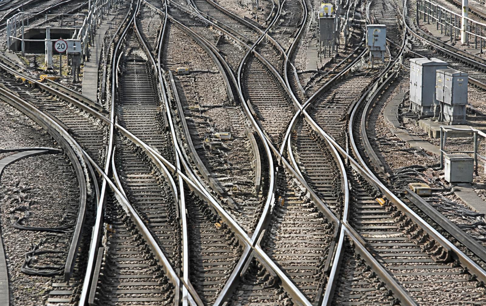Complex UK railway junction with polished silver rails and signalling equipment